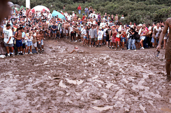 A Mud person enjoying mud sliding fun at the 1994 Woodstock II music festival.