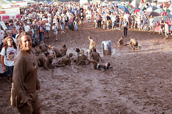 A group of Mud People at the 1994 Woodstock II music festival forcibly recruiting converts to their mud culture.